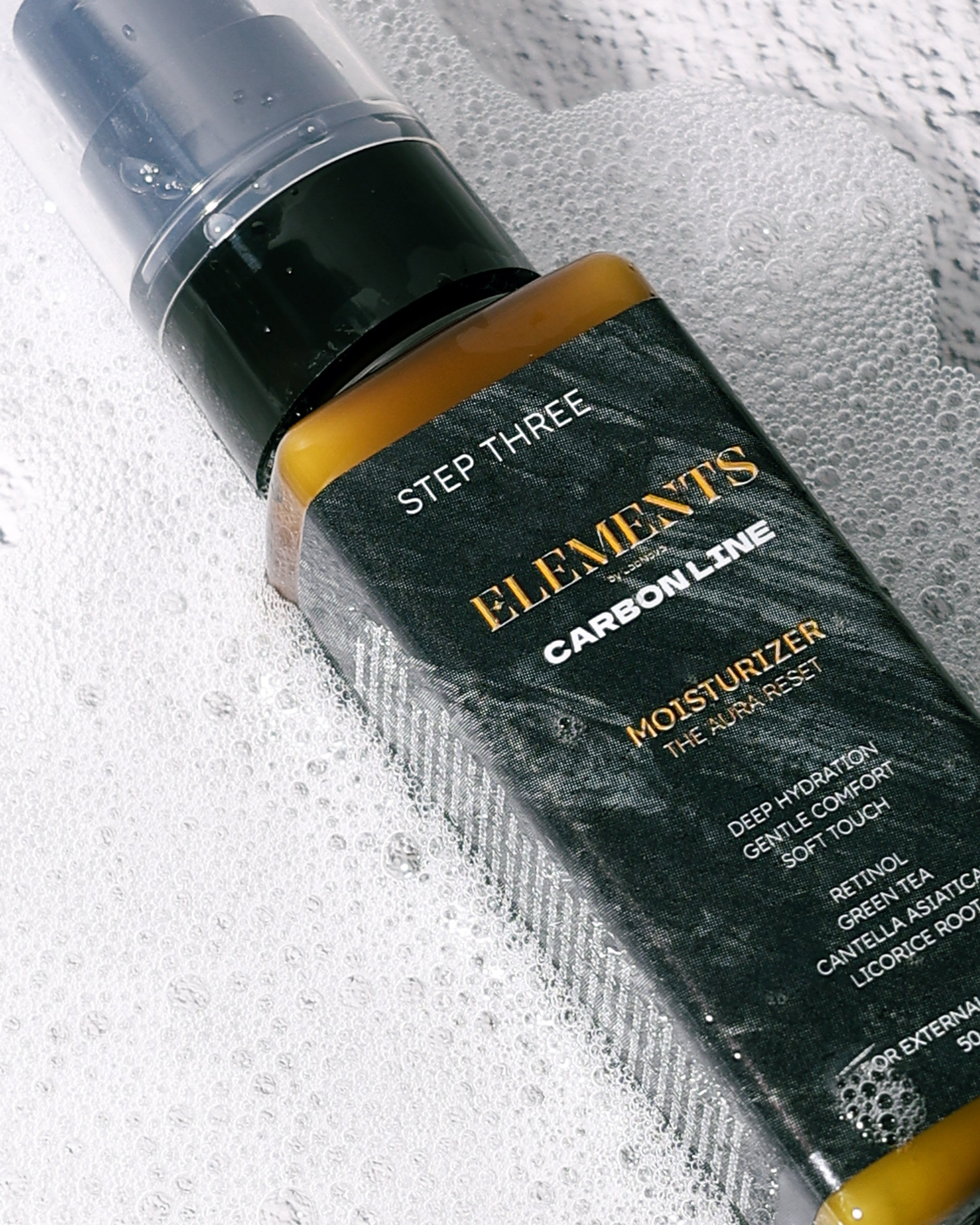Skincare bottle labeled 'Step Three Elements Carbon Line' on a textured background