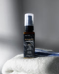Bottle of 'Elemente Carbon Line' hair product on a white towel with a gray background