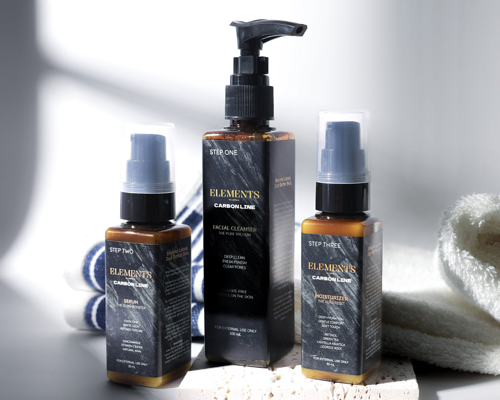 Three skincare bottles with pump and spray mechanisms on a white surface with a towel.